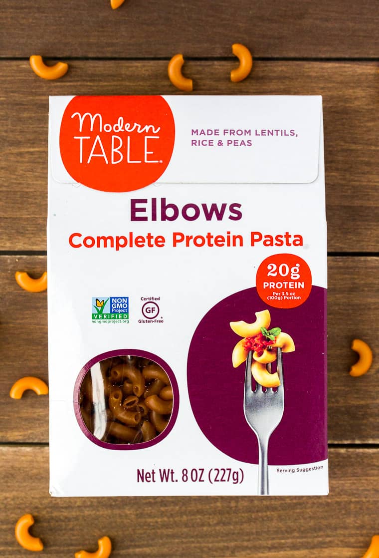 Modern Table Elbow Pasta on a Wood Backdrop with Elbow Pasta Scattered Around