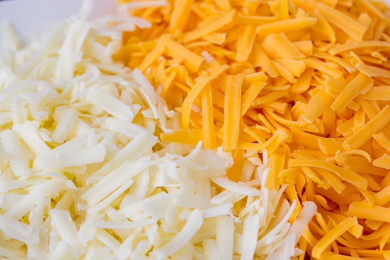 Yellow and White Cheddar Cheese Grated Up Close