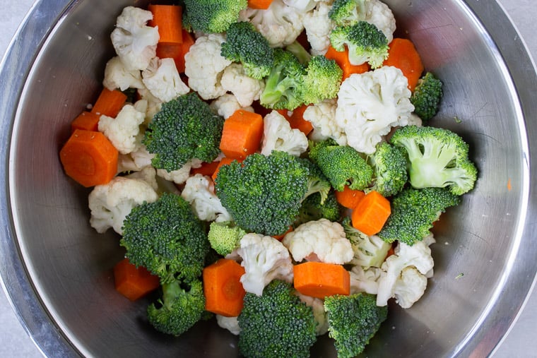 Broccoli, cauliflower, and carrots in a silver bowl