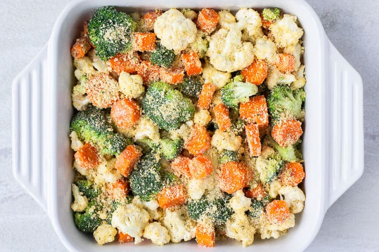 California blend vegetables in a white casserole dish before baking