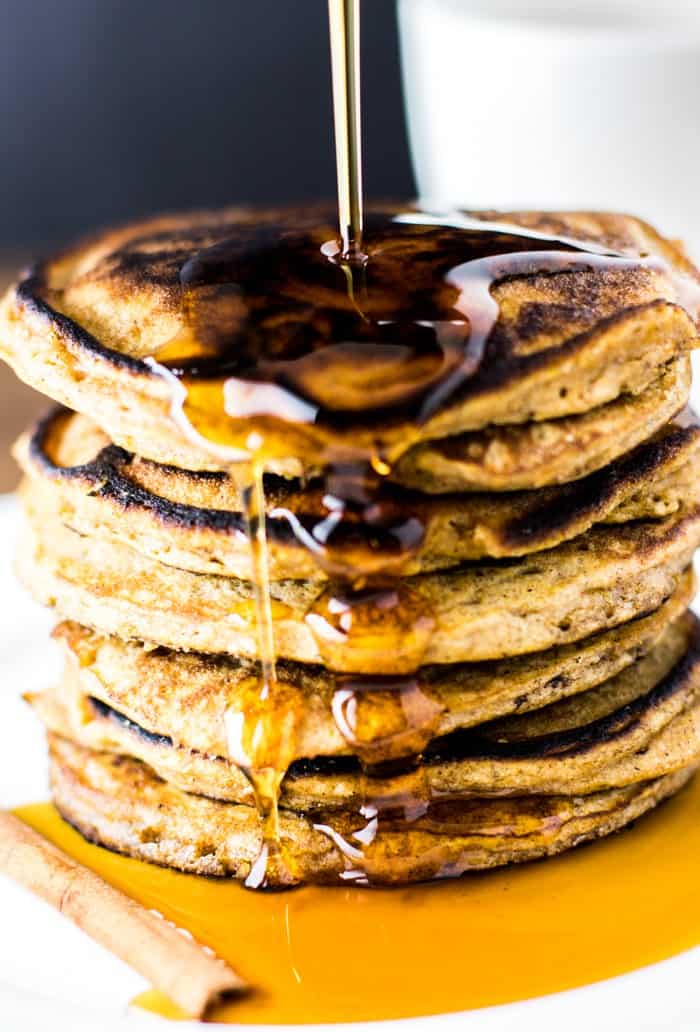 A Stack of Butternut Squash Pancakes with Syrup Poured On