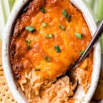Overhead of barbecue chicken dip with a spoon it in and text overlay