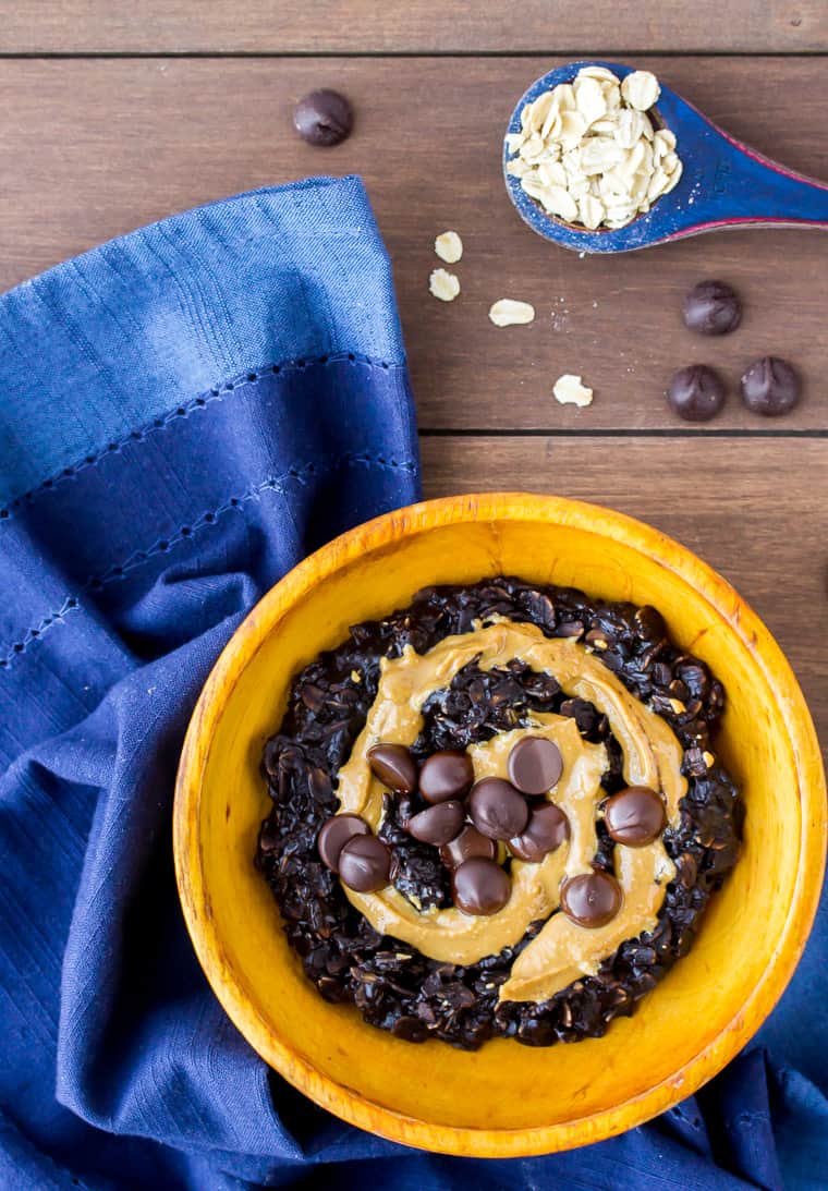 Dark Chocolate Peanut Butter Oatmeal in an Orange Wood Bowl with a Blue Napkin