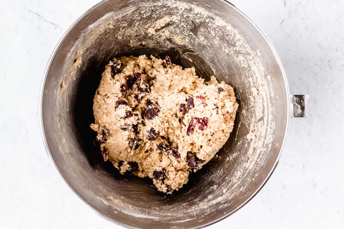 Oatmeal Cranberry Chocolate Chip cookies batter in a silver mixing bowl
