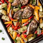 overhead of sheet pan italian chicken with potatoes and peppers on a baking sheet