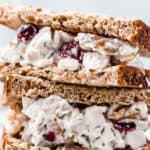 close up of cranberry walnut chicken salad sandwich with text overlay