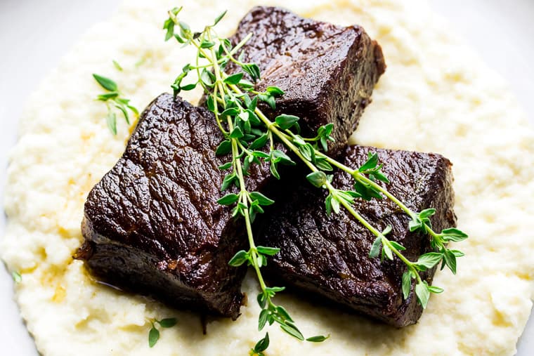 Garlic Butter Instant Pot Short Ribs Over Mashed Cauliflower and Topped with Fresh Thyme