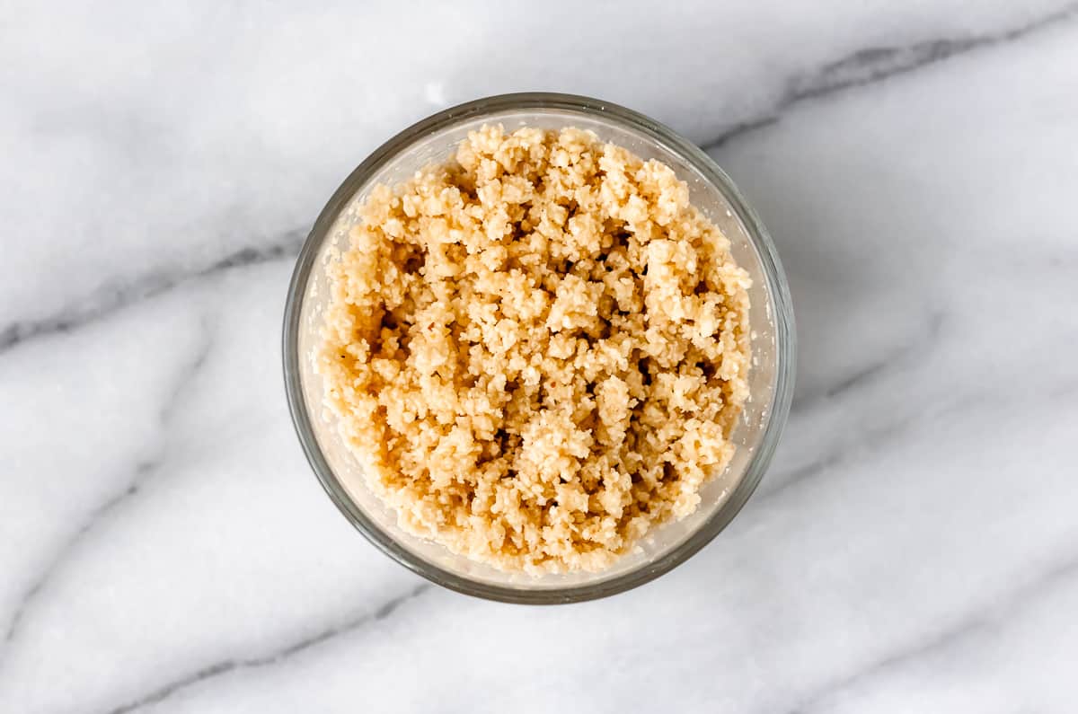 Almond flour bread crumbs in a glass bowl.