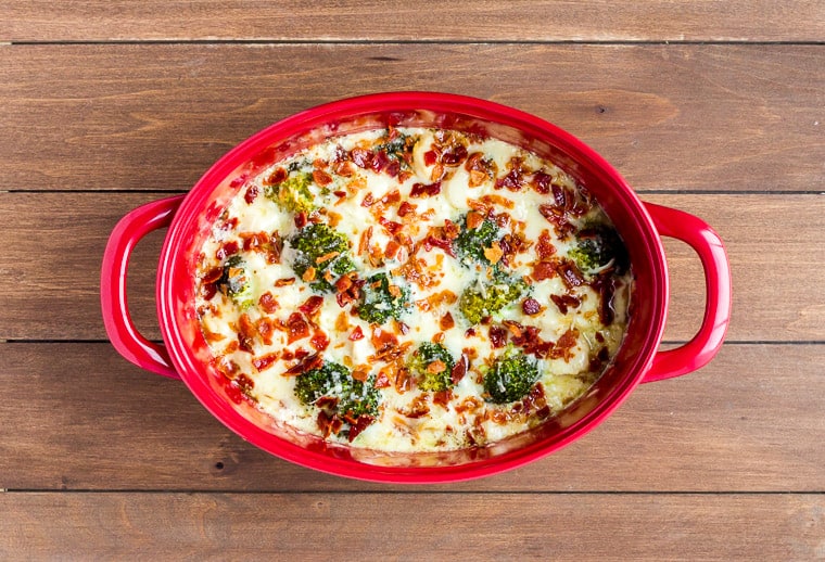 Baked Cheesy Chicken Casserole in a Red Casserole Dish on a wood background