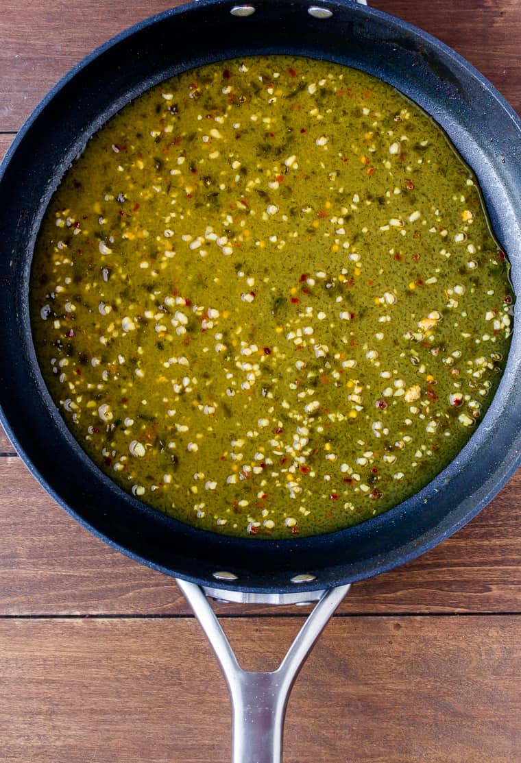 Overhead View of Cilantro Lime Sauce Cooking in a Skillet on a Wood Background