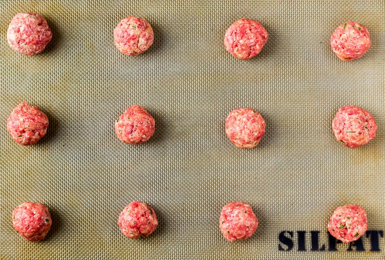 12 Meatballs Rolled Out Onto a silpat mat Baking Sheet