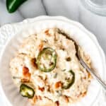 A serving of jalapeno popper chicken casserole with text overlay.