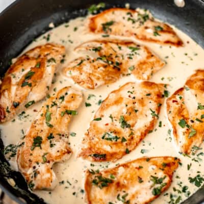 Creamy cilantro lime chicken in a black skillet.