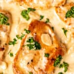 Close up of creamy garlic chicken with text overlay.