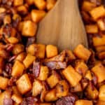 Close up view of Maple Bacon Sweet Potato Hash with a wood server and text overlay.