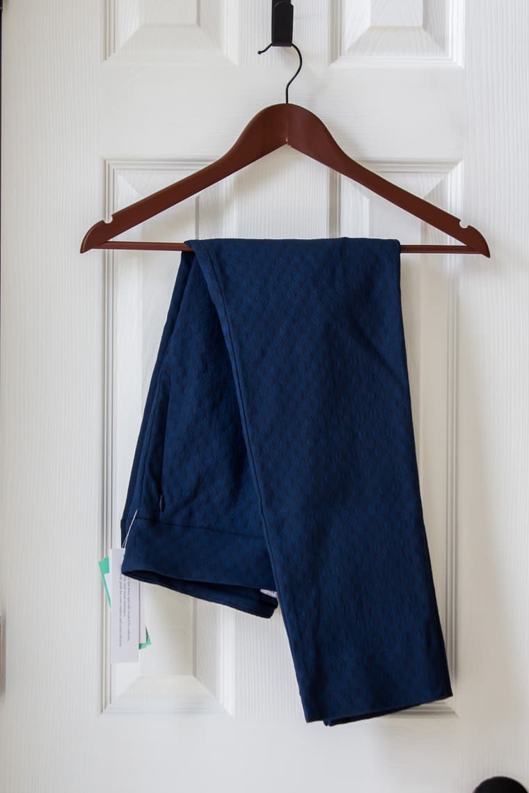 Margaret M Sylvie Printed Straight Leg Pant in dark blue on a hanger over a white door