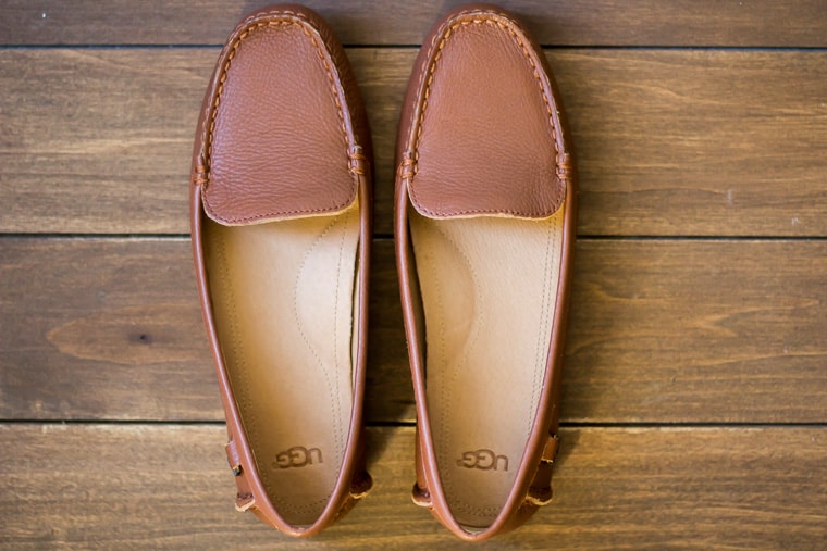 UGG Flores Driving Loafer in Cognac Leather on a wood backdrop