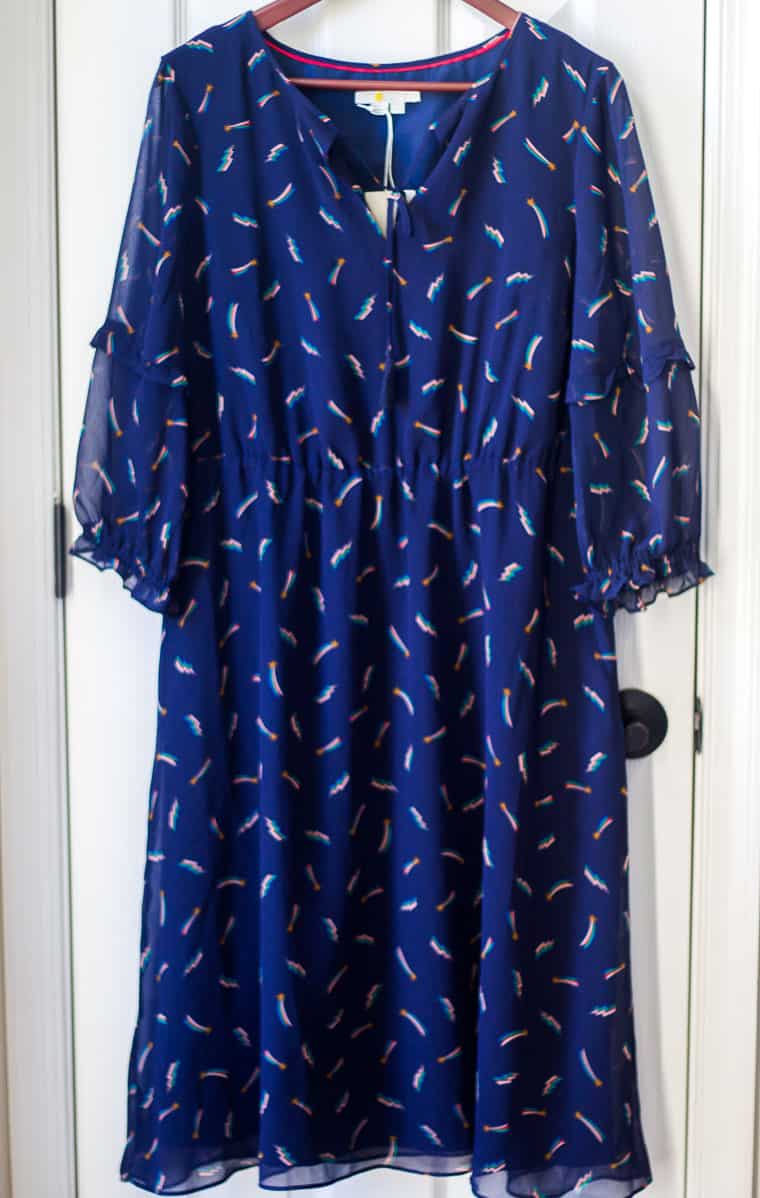 Boden Iona Tassel Tie Pattern Midi Dress in Navy on a hanger on a white door