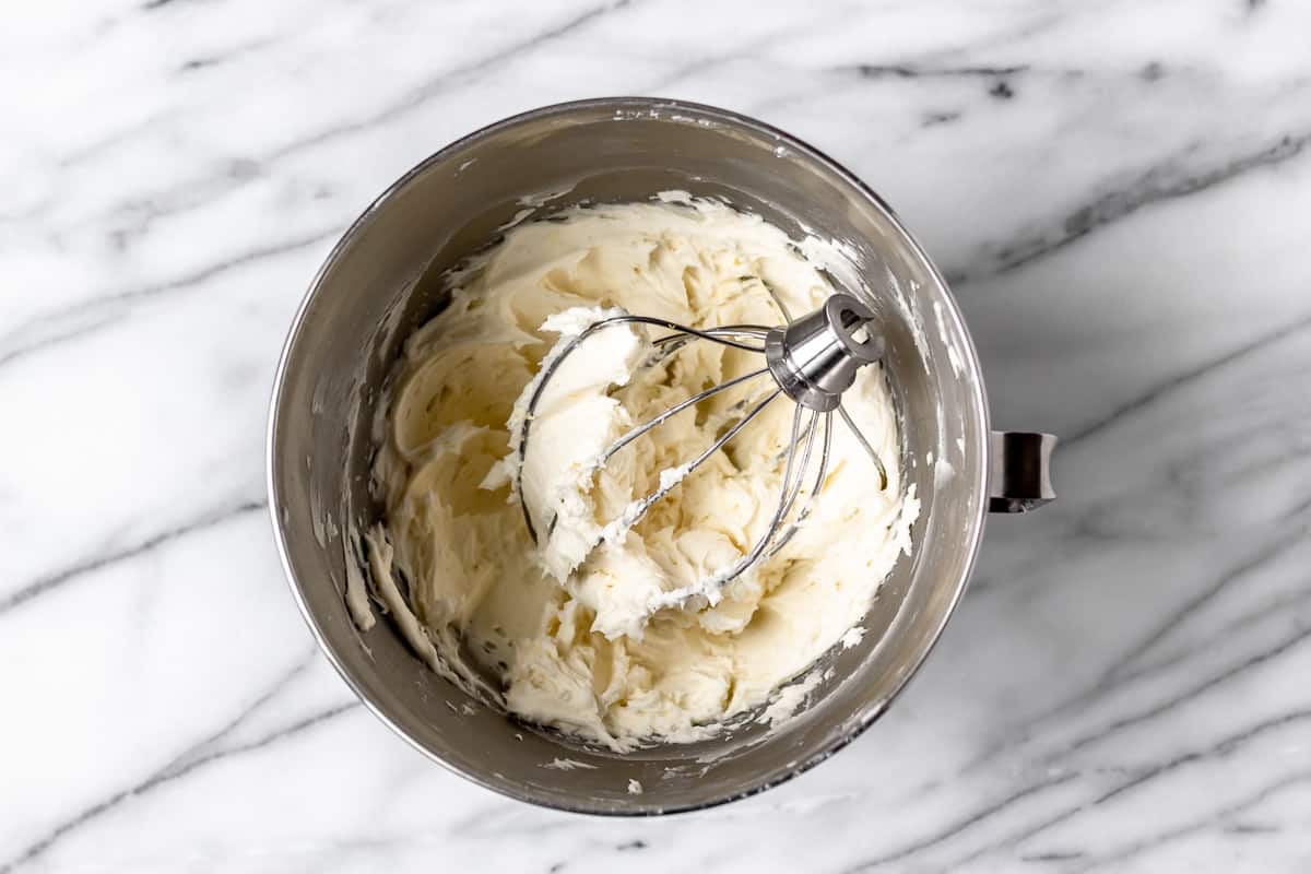 Lemon Buttercream Frosting in a mixing bowl with the whisk attachment.