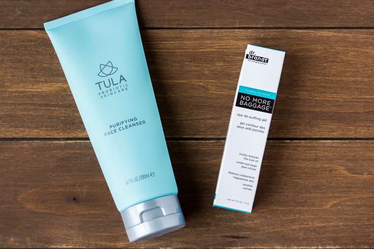 Tula Facial Cleaners and Dr. Brandt De-puffing eye gel on a wood backdrop