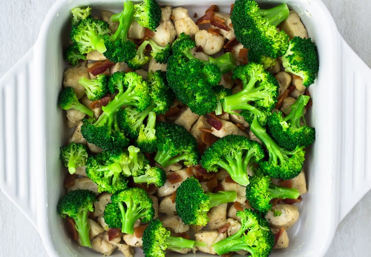 Chicken, broccoli, and bacon in a white casserole dish