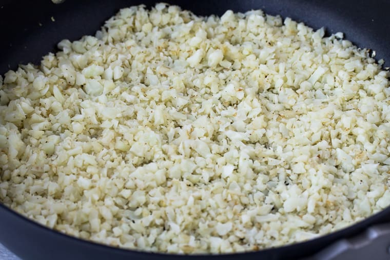 Close up of cooked cauliflower rice in a skillet