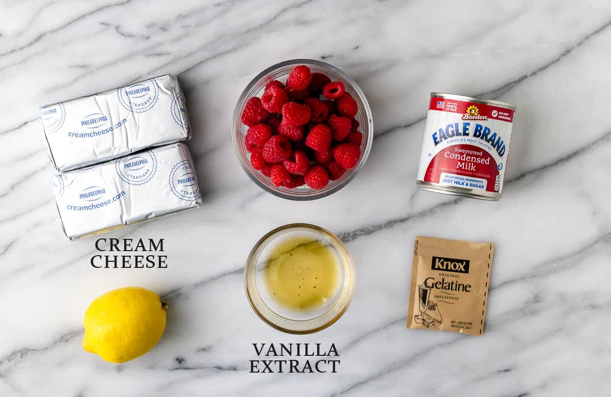 Ingredients needed to make no-bake raspberry cheesecake with text overlay.