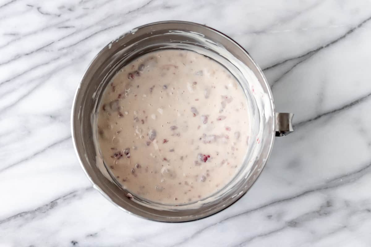 Raspberry no-bake cheesecake filling in a mixing bowl.