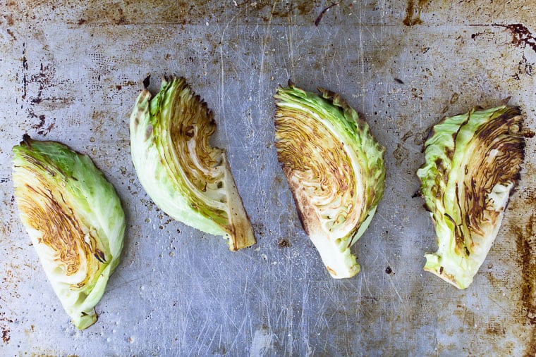 4 Roasted Cabbage Wedges on a baking sheet