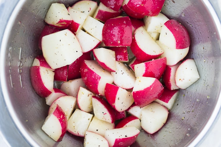 Quartered radishes in a silver bowl