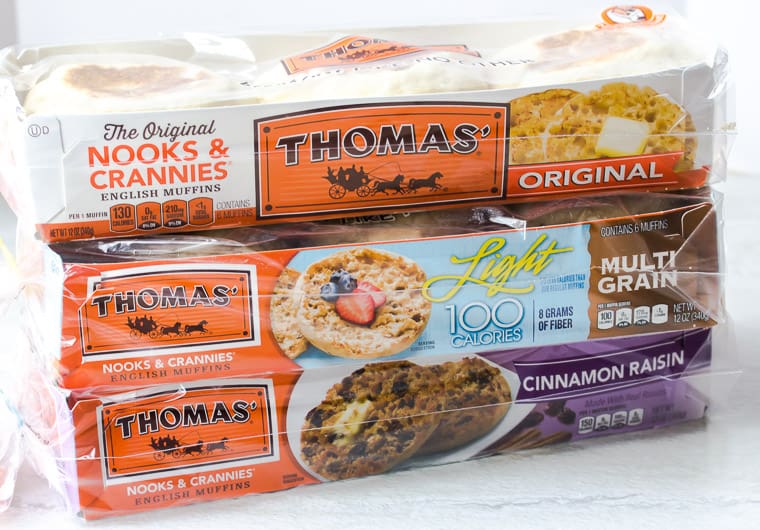 3 packages of thomas' english muffins on a white background