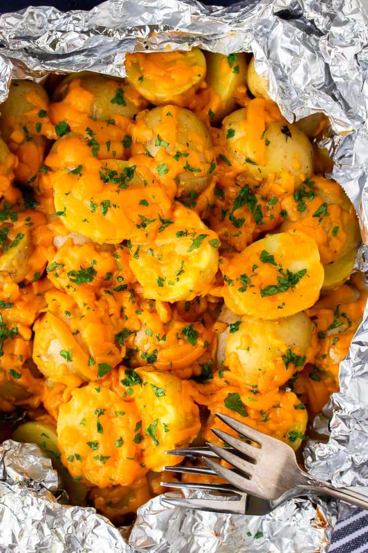 Cheesy Potatoes in a foil pack with 2 forks 