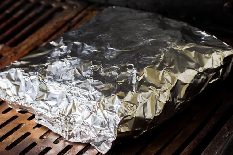 Close up on foil packet potatoes on the grill