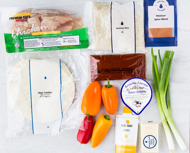 Ingredients for Blue Apron's Chicken Enchiladas spread out on a white background