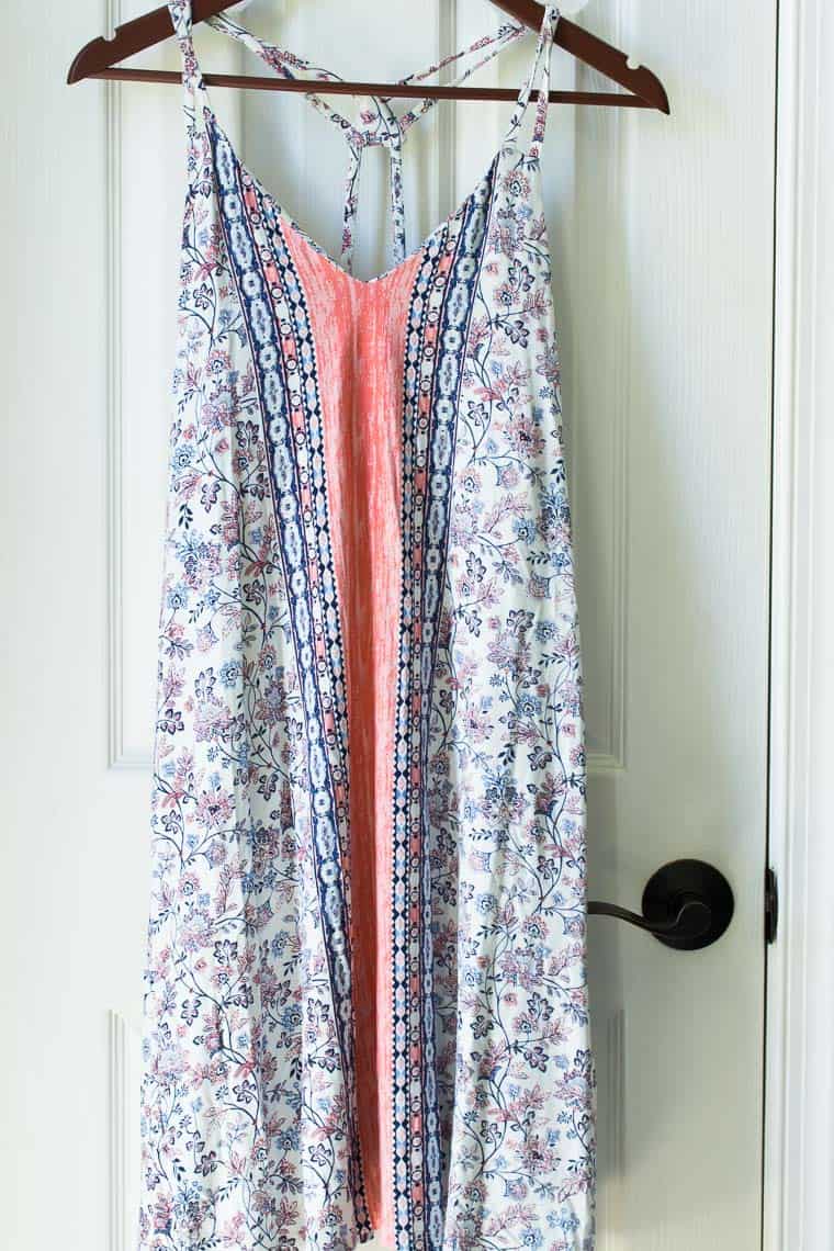 Blue and pink dress on a hanger in front of a white door