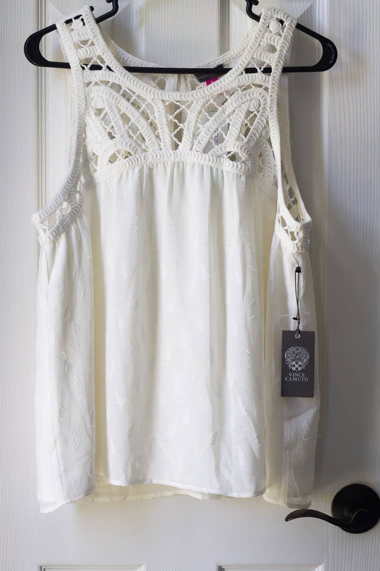 Stitch Fix Vince Camuto Monila Crochet Detail Texture Top in white on a hanger over a white door