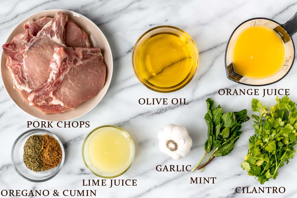 Ingredients needed to make grilled cuban pork chops with text overlay.