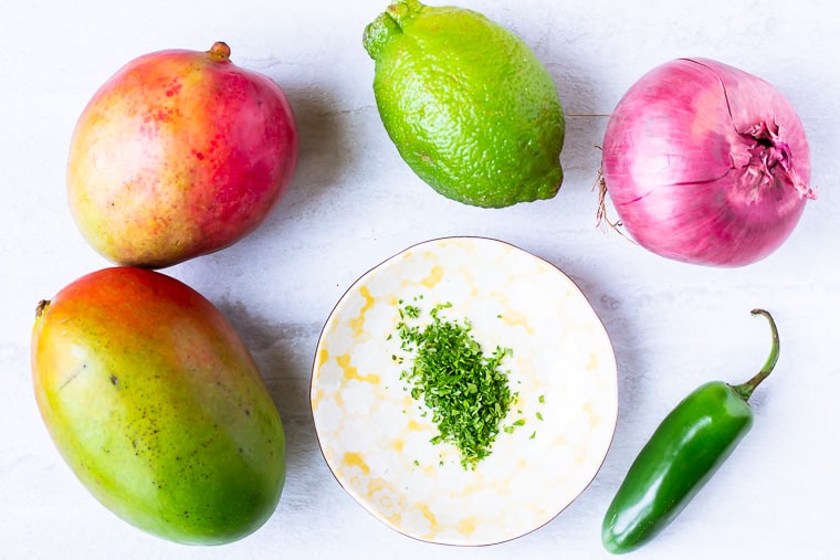 Ingredients for spicy mango salsa on a white background