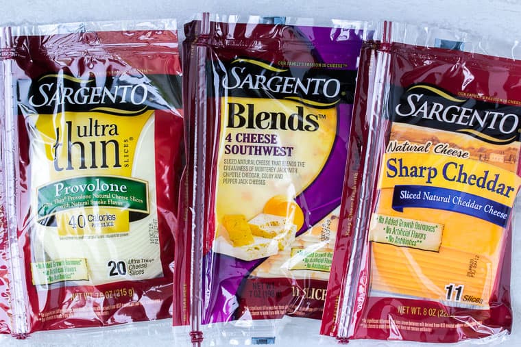 3 packages of Sargento cheese on a white background