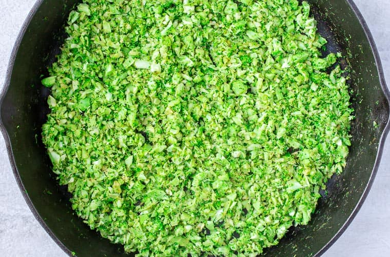 Broccoli rice cooking in a black skillet