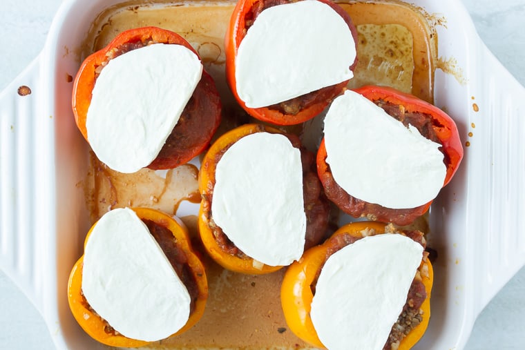6 Bake stuffed peppers in a whit casserole dish topped with fresh mozzarella cheese.