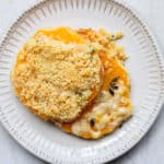 A serving of Butternut Squash Gratin on a small white plate over a white background