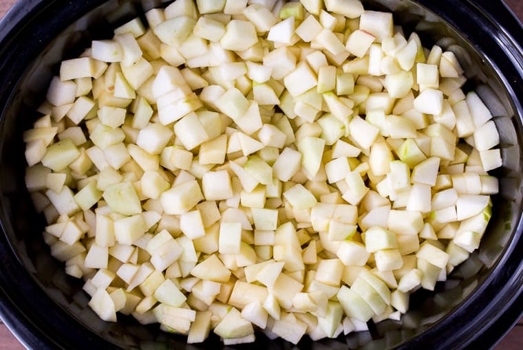 Diced apples in a black slow cooker