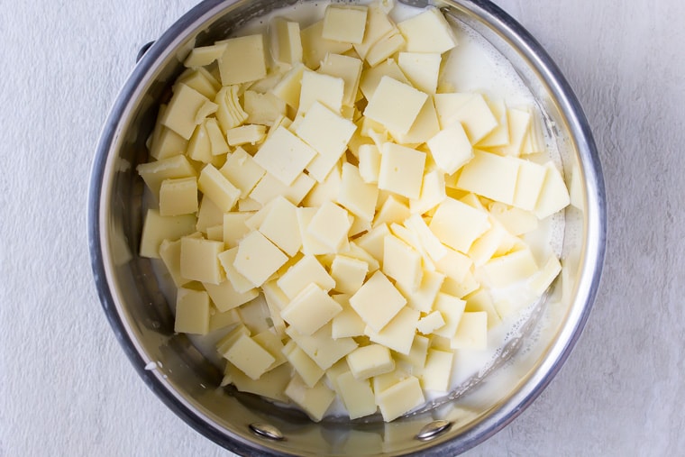 Diced American cheese in a silver pot