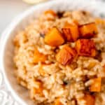Close up of lemon risotto with roasted butternt squash with text overlay.