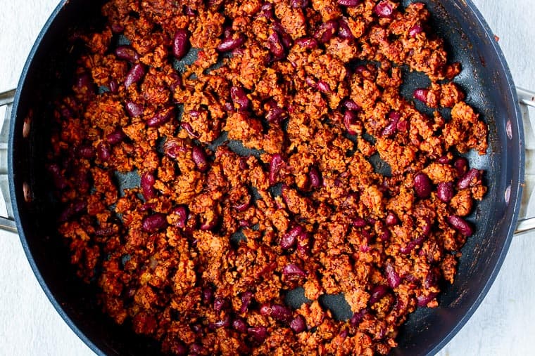 Vegetarian ground beef and kidney beans in a black skillet