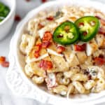 Close up of jalapeno popper chicken pasta in a white bowl.