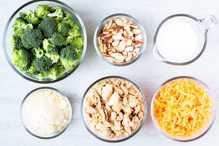 Ingredients needed for keto broccoli chicken bake on a white background