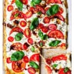 Caprese pizza with a slice being pulled away and text overlay