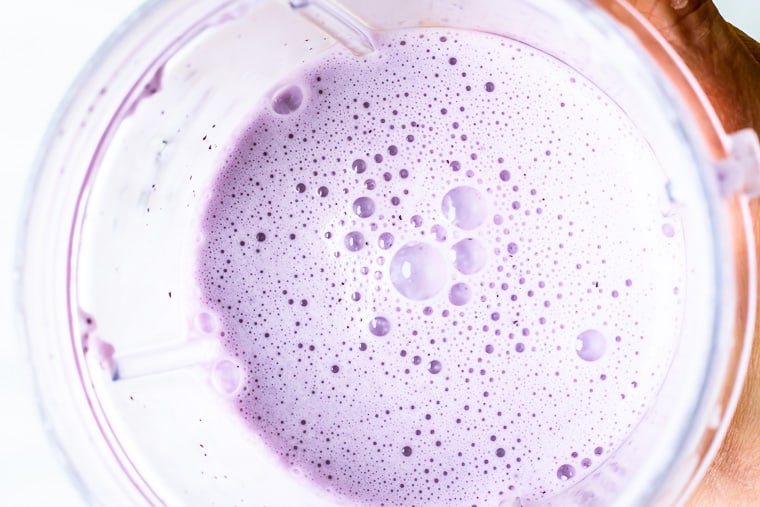 blueberry smoothie close up in a blender cup